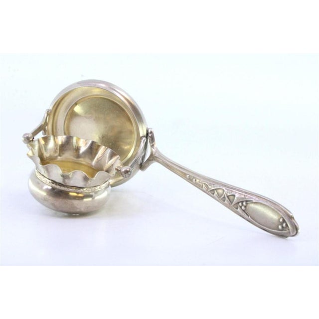 Silver Tea Strainer with Cup-Shaped Deposi, Handle Reliefs and Monogram Card, in Very Good conditions. Designed 1920 to...