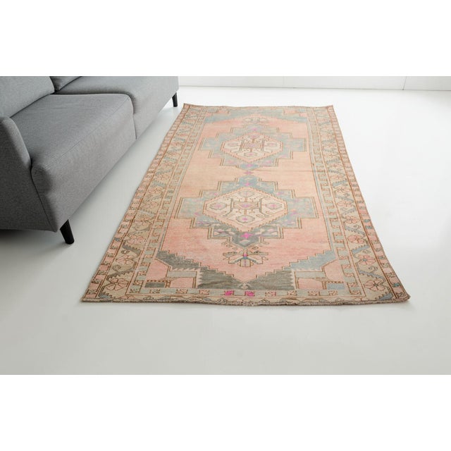 Add a touch of timeless elegance and warmth to your home with this beautiful, hand-knotted vintage Turkish rug. Featuring...