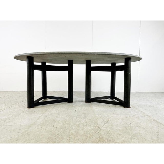 Vintage oval stone top dining table with a double tripod black metal base in the manner of Jan Vlug. Beautiful timeless...