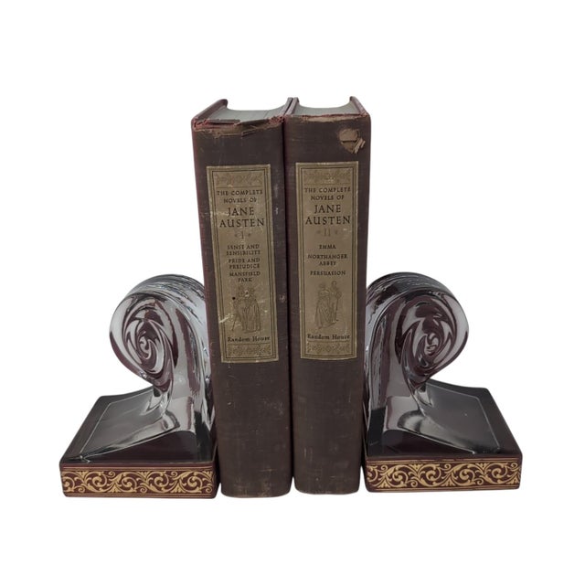 These elegant bookends feature a striking architectural design, blending heavy clear glass with a decorative "ribbon"...