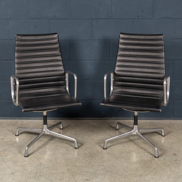 A pair of iconic ea117 office chairs designed by charles and ray eames, produced by vitra in the late 20th century. One of...