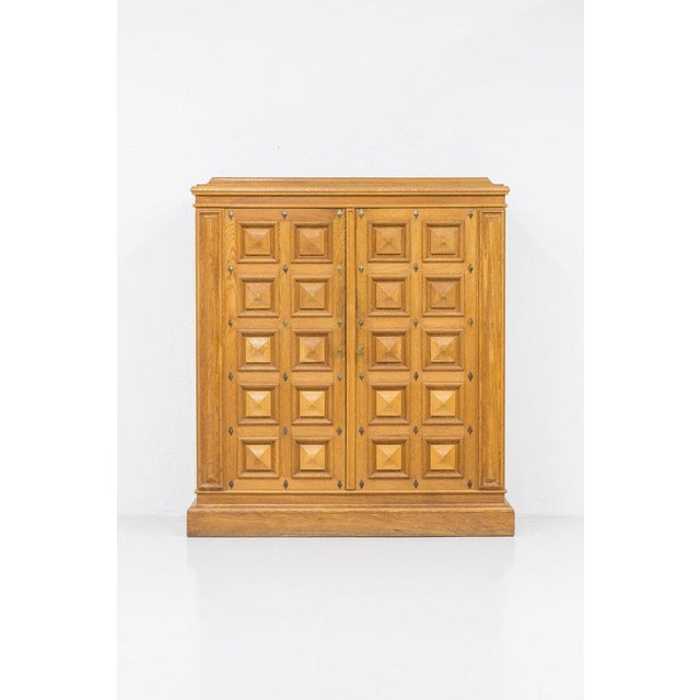 Norwegian Art Deco cabinet made during the 1920-30s. Made from oak with brass details. Heavy geometrical relief patterned...