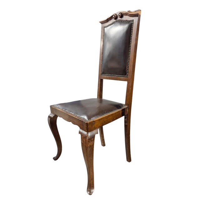Elegant early 20th-century French Provincial side chair featuring a solid wood frame with hand-carved crest detailing and...