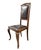 Elegant early 20th-century French Provincial side chair featuring a solid wood frame with hand-carved crest detailing and...