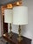 Design Plus Gallery presents a Pair of Vintage Brass Table Lamps. This vintage pair has turned brass forms with tiered...