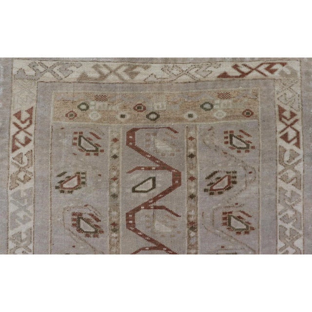 Measures: 3'5 x 6'2 This one-of-a-kind Turkish Oushak has a light taupe colored background reaching the field and the...