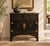 A compact two-door cabinet in black paint, with warm brown showing through at the edges where the finish has worn. Two...