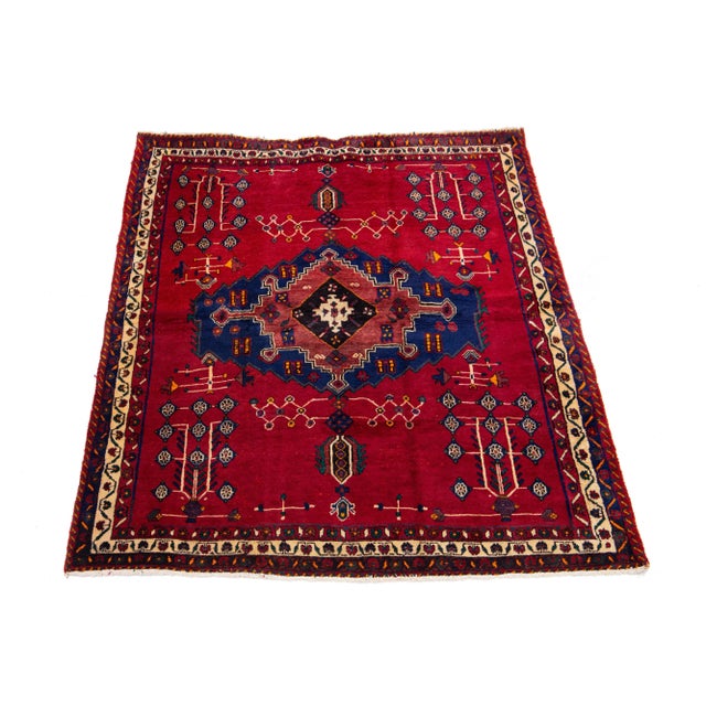 Vintage Shiraz Handmade Wool Rug. This rug has a red field with a multicolor medallion design. This rug measures 5'9" x 7'2".
