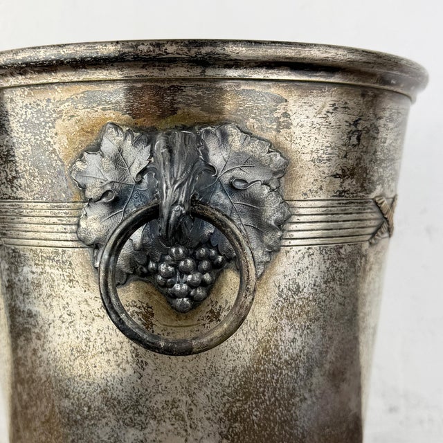 Antique French champagne bucket by Argit Paris, featuring decorative grapevine motifs with grape clusters, leaves, and...