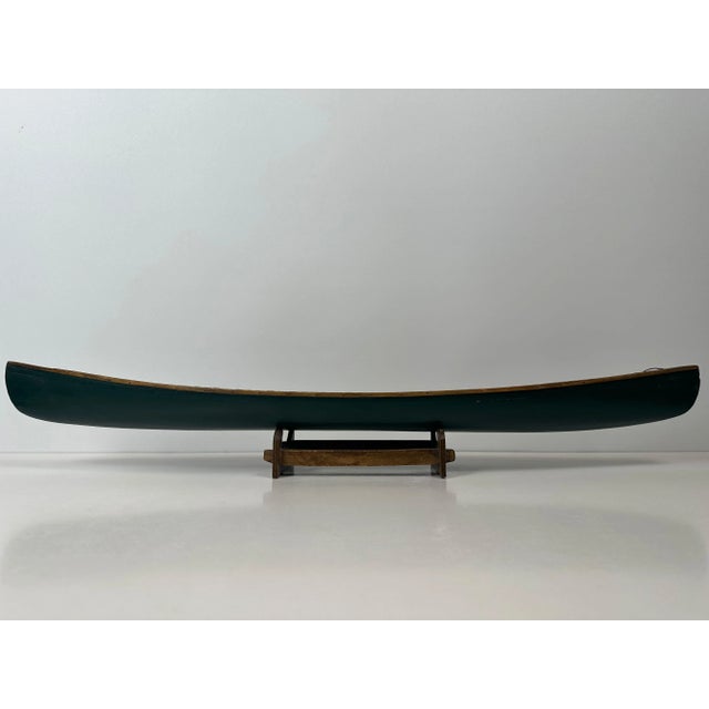 Vintage wooden canoe model. Includes two woven seats, two paddles, and a support. Beautifully detailed. Length: 70cm....