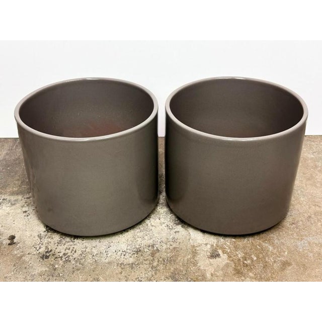 A pair of Gainey Ceramics gray glazed ceramic planters. Both planters are in good condition with no chips, cracks or...