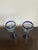 Beautiful pair of artisan hand-blown glass goblets featuring rich cobalt blue rims and matching blue bases. The clear...