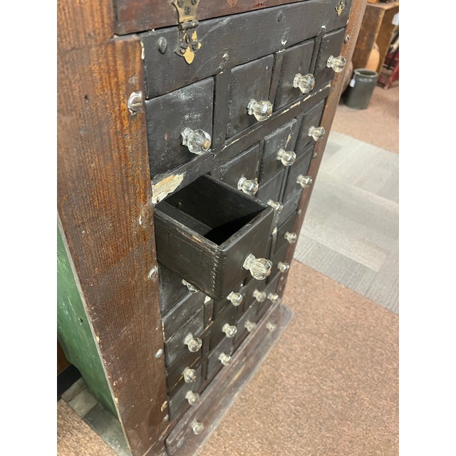 This antique multi-drawer storage unit is a classic piece of 1920s American folk art upcycling made out of vintage wooden...