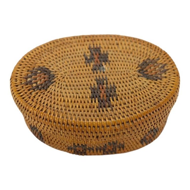 This antique Southwest American lidded oval basket, circa 1920, exemplifies traditional weaving techniques. Crafted from...
