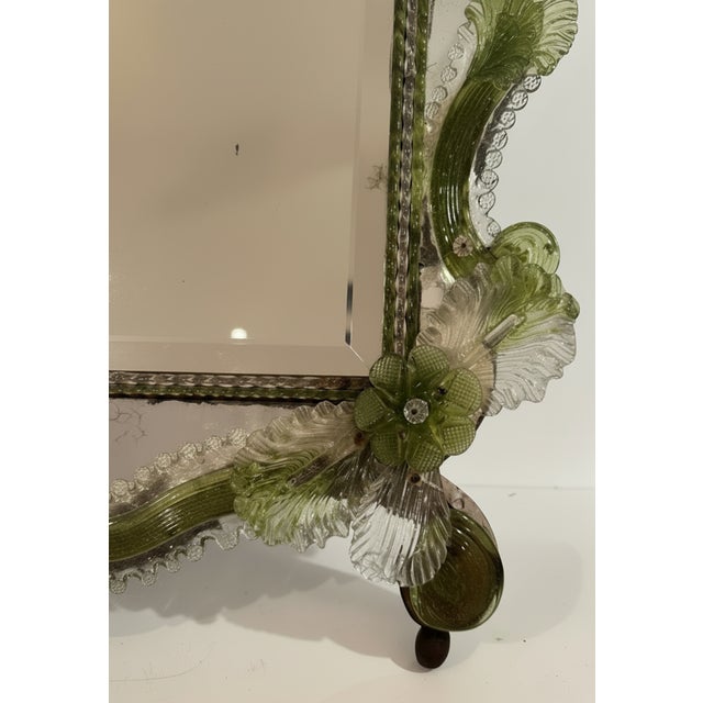 Gorgeous vintage 1950s Venetian Murano glass mirror, featuring a characteristic ornate, scalloped silhouette adorned with...