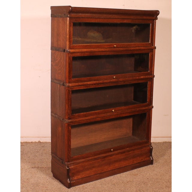 Elegant Globe Wernicke London oak bookcase from the late 19th/early 20th century, England, comprising four sections. This...
