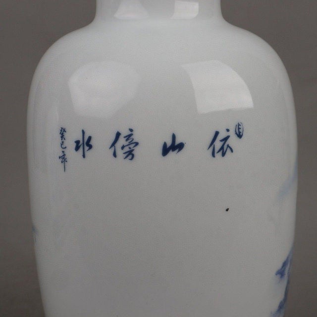 This is a magnificent pair of vintage Chinese porcelain vases, beautifully decorated in the classic "Blue and White with...