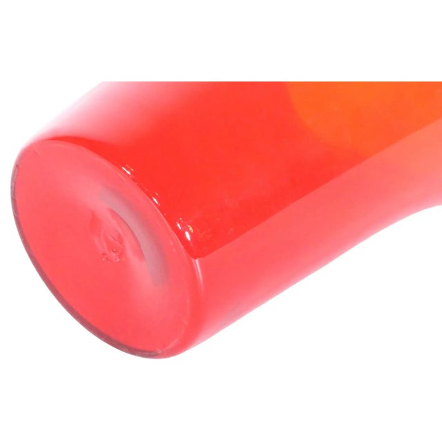 Classic Mid Century glass vase in saturated red color. The vase features a flared four with four distinct sides at the...