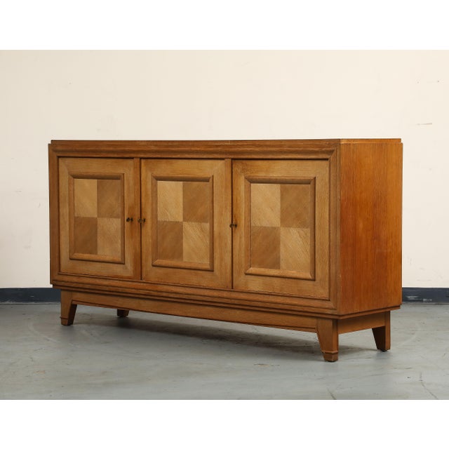 1940s French Art Deco oak sideboard, with three keyed cabinet doors. Classic Art Deco details include the diamond...