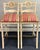 Pair of French Country style wooden barstools featuring a distressed white or cream finish, ladder-back design, with...