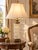 A monumental vintage French Neoclassical table lamp combining a tall, brilliantly patterned crystal body with ornate...
