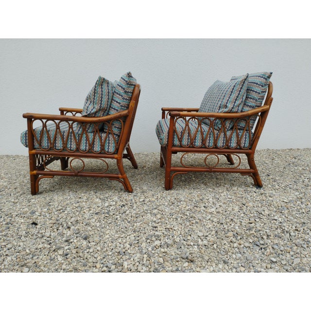 Pair of vintage armchairs. 2 vintage rattan armchairs with 3 cushions. the cushions have been remade by the previous...