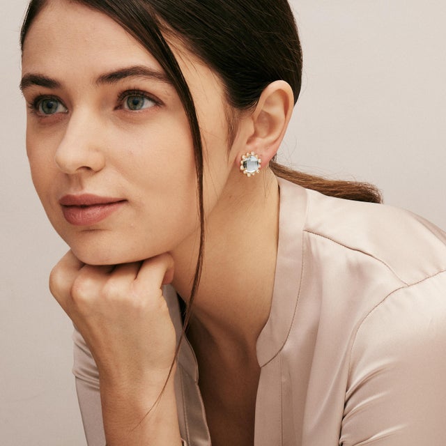 Created in 18 karat yellow gold Blue Topaz 12 carats approx. Diamonds 0.50 carat approx. Omega clip-backs & posts Limited...