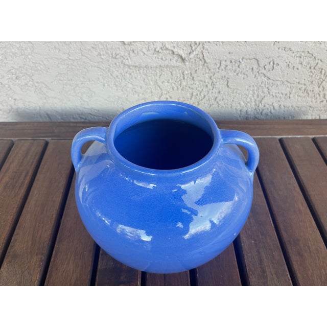 I believe this is a beautiful piece of glossy blue double handle art pottery and is in the style of Zanesville or Ohio...