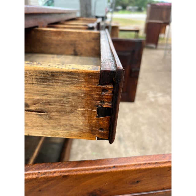 French 18th-century Louis XV country buffet crafted in richly figured walnut, featuring two paneled doors, three drawers,...