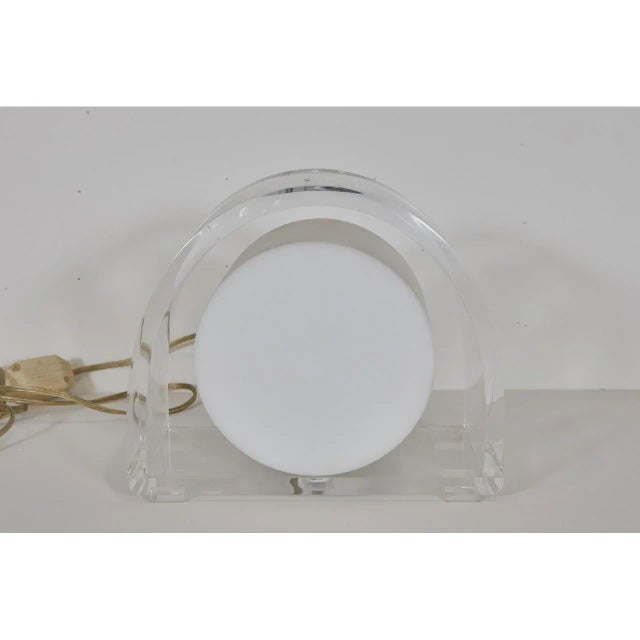 This exquisite demilune lucite lamp is made by the Ritts Company. The lamp has a milk lucite circular light fixture set in...