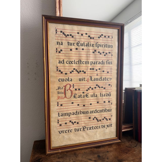 This is a framed piece of Gregorian chant music. This is an antique. I believe this is done of a piece of animal skin or...