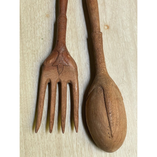 This is a fantastic French country hand carved fork and spoon that are intended to be a salad serving set but I see them...
