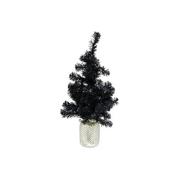 This unique vintage black Christmas tree set in a mercury glass base adds a bold twist to classic holiday decor. Its dark,...