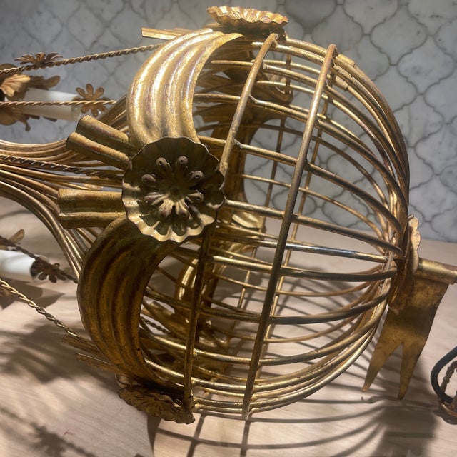 An extraordinarily rare Italian gilt iron hot air balloon chandelier, sculptural in scale and rich in Old-World fantasy. A...