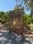 A beautiful antique fireplace screen featuring an intricately embroidered crane and botanical scene, framed in richly...