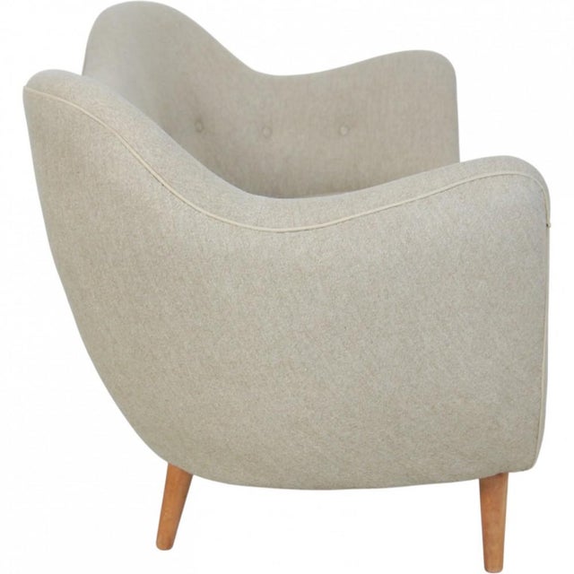 Finn Juhl 2.seater sofa, model BO46, upholstered in beige fabric and with legs of beech. The sofa is from the 1950s and...