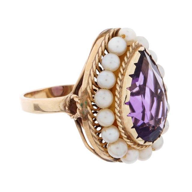 14K Gold Band cabochon set pear form Amethyst Ring, Size 5.. Stone is approximately 15mm x 10mm, above a band of seed...