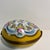 Very charming Limoges egg shaped box with blue, print, gold, green and yellow accents on a white ground. Ceramic and...