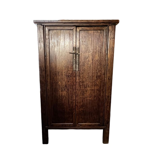 The tall cabinet with double doors and slightly recessed sides represents traditional Chiinese furniture craftsmanship...