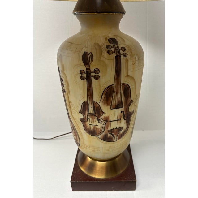 Stunning MCM handpainted stringed instrument lamp, with a mint metallic fiber shade . Mandolin, violin, and cello Circa...