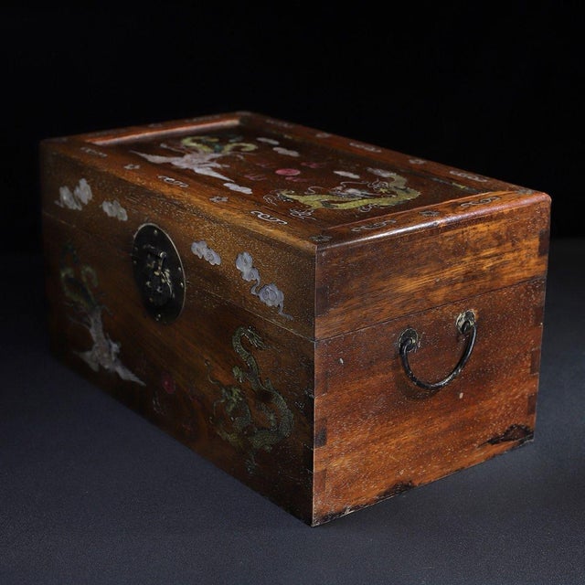 A beautifully crafted Chinese rectangular box, likely made of Huali (rosewood). The box features a hinged lid with brass...