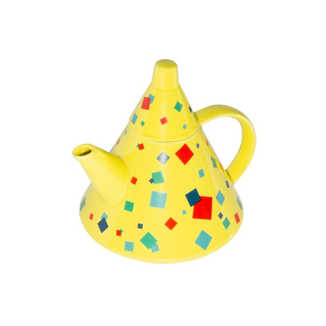 A Postmodern ceramic teapot designed by the Toscany Collection. The cone-shaped teapot is bright yellow with a square...