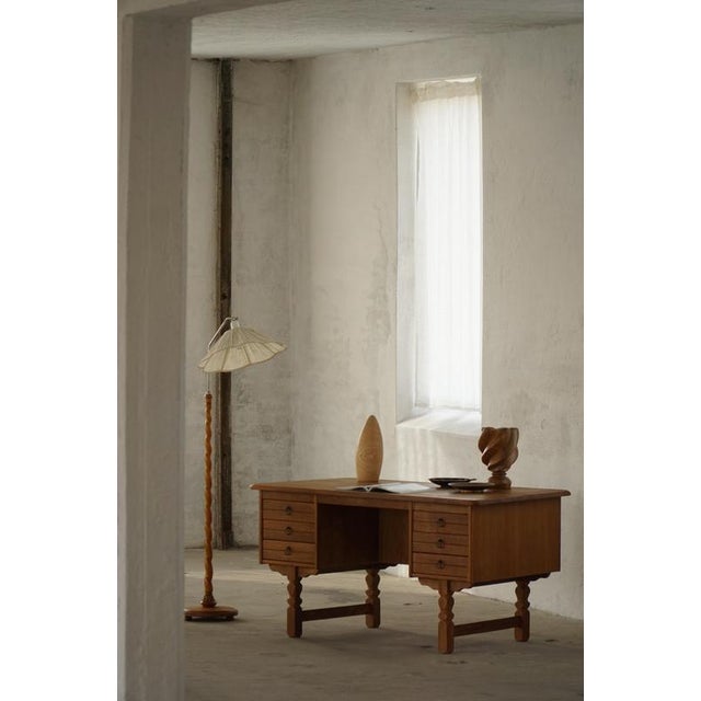 An elegant freestanding writing desk designed by Danish designer Henning Kjærnulf in the 1950s. Crafted in rich oak, the...