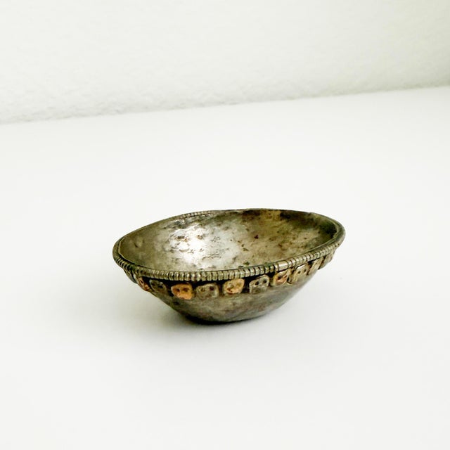 Small, handmade, silver-lined traditional Tibetan Kapala offering vessel featuring skull design around the perimeter....