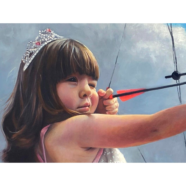 In "Impenetrable Princess," a young girl in a delicate dress confidently draws back a bow, poised against a backdrop of...