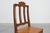 An elegant carved oak side chair from 18th‑century France, executed in the Régence style. The chair features a scrolled...