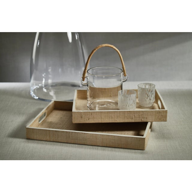 Artisan crafted of wood and then covered with natural raffia fiber, with white cow leather trim piping and open cut side...