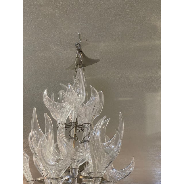Illuminate your space with the timeless allure of this Mid-Century Modern Italian Hand-Blown Murano Glass Chandelier....