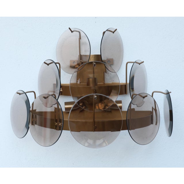 A pair of eye-catching 1970s wall lamps with smoked glass shades. The frames of both lamps have been fully restored. They...