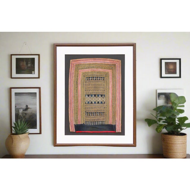 This framed textile offers a captivating glimpse into the rich tradition of Chinese embroidery, likely originating from...